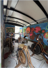 interior of the CCAT MEOW, a medium sized trailor with two bikes and a blue and pink mural on the wall